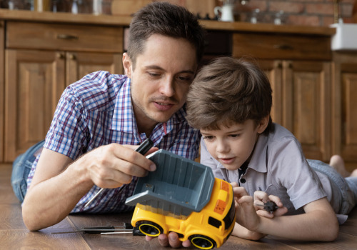 Father playing with his child after winning custody with help from Child Custody Attorneys in Peoria IL