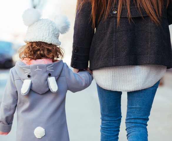 Woman holding the hand of their daughter after the completion of child custody arrangements in Washington IL