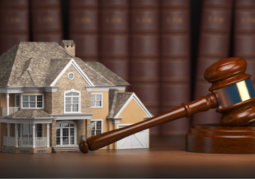 a house in front of a gavel on a desk