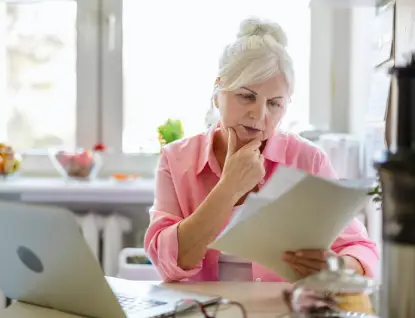 A woman looks over paperwork from Essig Law Office, which offers property & estate law