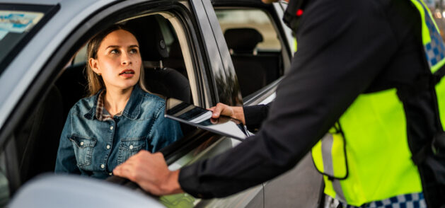 A police officer stops a woman for Traffic Violations