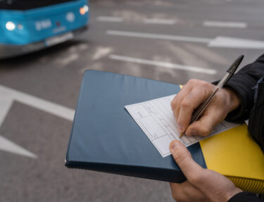 a police officer writes a ticket for traffic violations